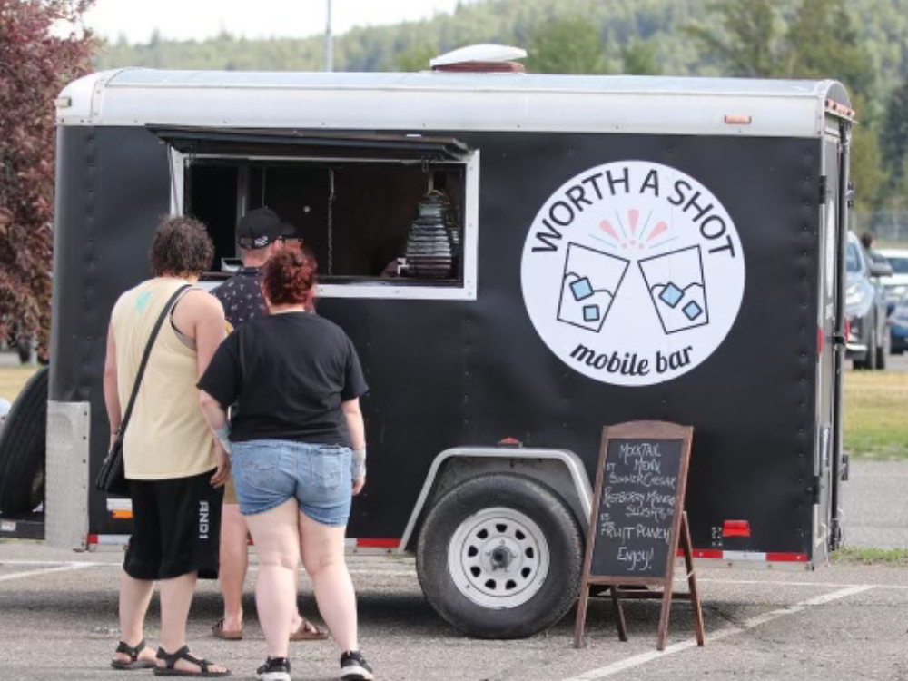 Bartending Trailer with people standing outside and getting drinks at a community event